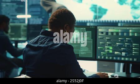Cyber security expert working on encryption and IT security in a governmental agency. Woman engaging on cyber operations, network security and data protection for hybrid war. Camera A. Stock Photo