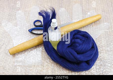 workshop of hand making a fleece gloves from Merino sheep wool using wet felting process - set of equipment to make felt on mat Stock Photo