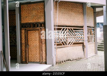 Traditional bamboo and woven wood building with intricate patterns, showcasing authentic Indonesian architecture and craftsmanship, blending cultural Stock Photo