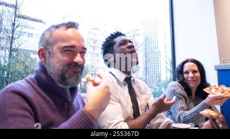Team Bonding Over Pizza and Laughter Stock Photo