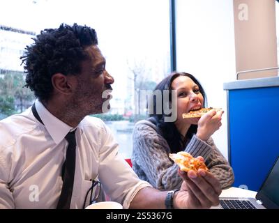 Colleagues Sharing a Pizza Moment Stock Photo