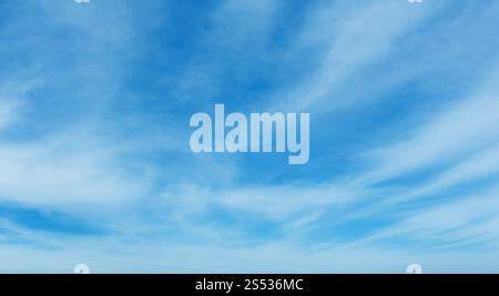White cirrus fuzzy clouds in the blue azure sky. Summer good weather background. Stock Photo
