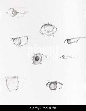 sketches of human eyes hand-drawn by black pencil on white paper Stock Photo