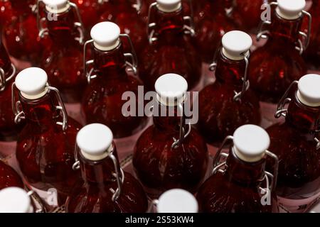 A Close-Up View of a Rows of Clear Red Bottles in a Factory Setting Stock Photo