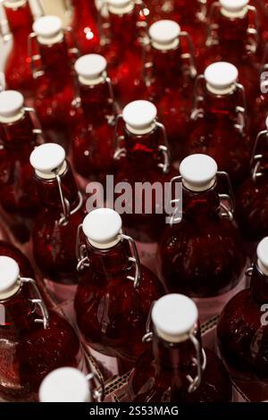 A Close-Up View of a Rows of Clear Red Bottles in a Factory Setting Stock Photo