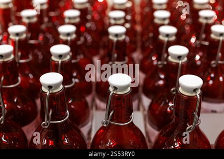 A Close-Up View of a Rows of Clear Red Bottles in a Factory Setting Stock Photo