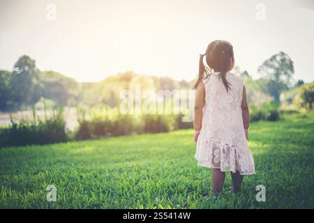 Smiling young girl standing in the park, happy time Stock Photo