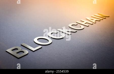 Word blockchain written with white solid letters on a board Stock Photo