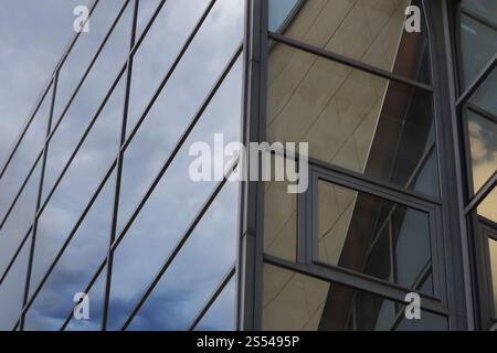 Close-up of the business center window panes. Reflection of an overcast sky in the windows of a modern house. Stock Photo