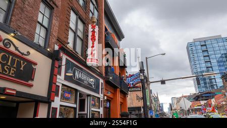 NASHVILLE, TN - 15 MAR 2024: Buildings with neon signs on Broadway in Nashville, Tennessee. Stock Photo