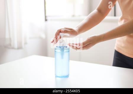 Hand applying Alcohol gel sanitazer liquid cleaning hands for prevent corona virus covid-19 Stock Photo