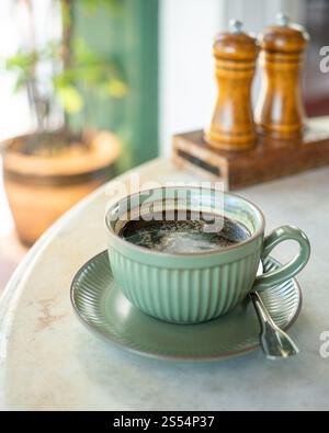 Cup of hot black coffee on table. Stock Photo