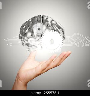 Thinking about structuring virtual diagram of business process with solutions. businessman hand showing 3d metal human brain as concept Stock Photo