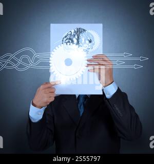 Thinking about structuring virtual diagram of business process with solutions. businessman hand show book of 3d metal brain as concept Stock Photo