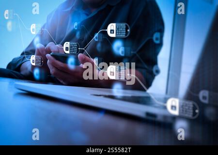 Blockchain technology concept with diagram of chain and encrypted blocks. designer hand working and smart phone and laptop on wooden desk in office Stock Photo