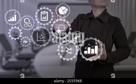 Business data analytics management with connected gear cogs with KPI financial charts and graph.businesswoman with an open hand as showing something Stock Photo
