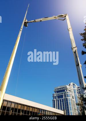 Image of machine crane doing montage works on high spire. Photo of machine crane doing montage works on high spire Stock Photo