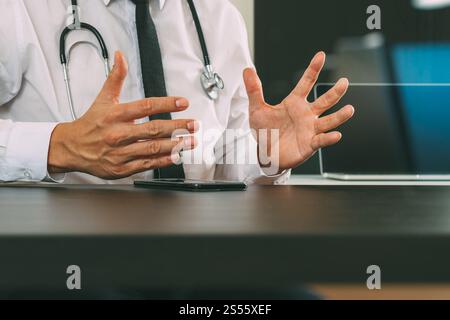 smart medical doctor working with smart phone and digital tablet computer and stethoscope on wood desk in modern office Stock Photo