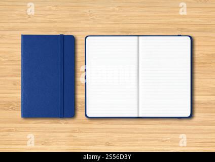 Marine blue closed and open lined notebooks mockup isolated on wooden background. Marine blue closed and open lined notebooks on wooden background Stock Photo