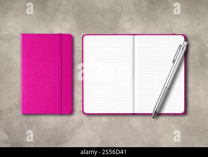 Pink closed and open lined notebooks with a pen . Mockup isolated on concrete background. Pink closed and open lined notebooks with a pen on concrete Stock Photo