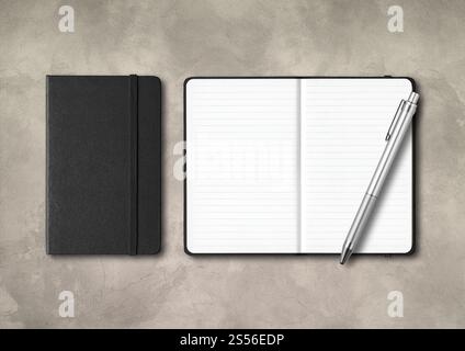 Black closed and open lined notebooks with a pen . Mockup isolated on concrete background. Black closed and open lined notebooks with a pen on Stock Photo