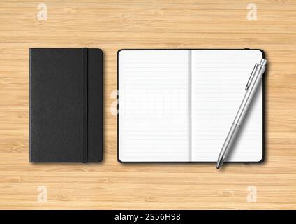 Black closed and open lined notebooks with a pen. Mockup isolated on wooden background. Black closed and open lined notebooks with a pen on wooden Stock Photo