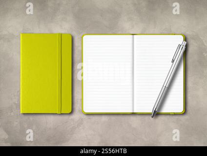 Lime green closed and open lined notebooks with a pen . Mockup isolated on concrete background. Lime green closed and open lined notebooks with a pen Stock Photo
