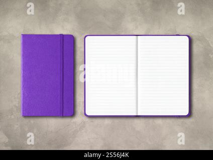 Purple closed and open lined notebooks mockup isolated on concrete background. Purple closed and open lined notebooks on concrete background Stock Photo