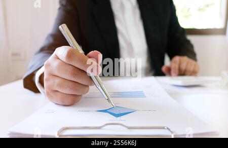 Accountant Working man uses calculator with Spreadsheet document, information financial concept Stock Photo