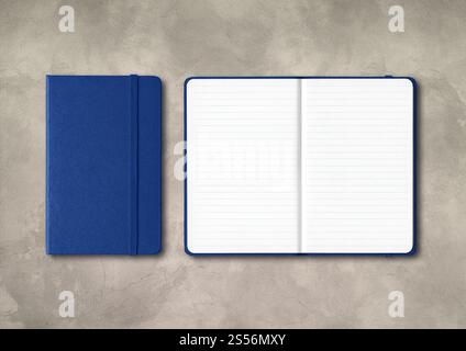 Marine blue closed and open lined notebooks mockup isolated on concrete background. Marine blue closed and open lined notebooks on concrete background Stock Photo
