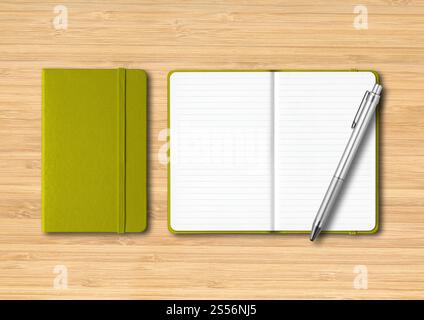 Olive green closed and open lined notebooks with a pen. Mockup isolated on wooden background. Olive green closed and open lined notebooks with a pen Stock Photo