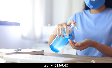 Hand applying Alcohol gel sanitazer liquid cleaning hands for prevent corona virus covid-19. woman hand sanitizer Alcohol gel gel for hand hygiene Stock Photo