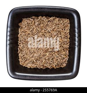 top view of caraway seeds in black bowl isolated on white background Stock Photo