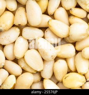 square food background - shelled pine nuts close up Stock Photo