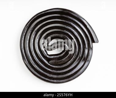 top view of spiral from black liquorice candy on white plate Stock Photo