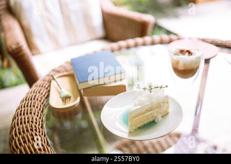 Coconut Cake and Coffee in a cafe on the blur background. traditional dessert Sliced of delicious coconut layer cake. Stock Photo