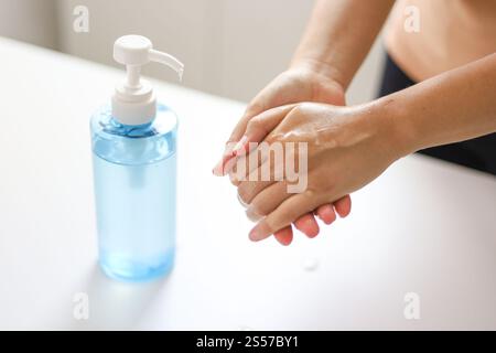Hand applying Alcohol gel sanitazer liquid cleaning hands for prevent corona virus covid-19 Stock Photo