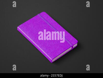 Purple closed notebook mockup isolated on black. Purple closed notebook isolated on black Stock Photo