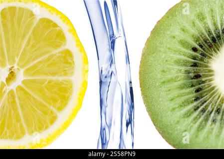 citrus fruit splashing isolated on white background. sliced lime with lemon splashing in water isolated Stock Photo
