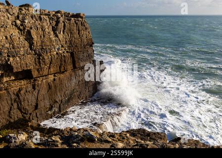 Waves crashing onto rocks at Anvil Point, Durleston, Dorset, UK Stock Photo