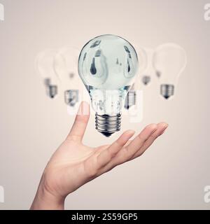 hand showing 3d light bulb as vintage concept Stock Photo