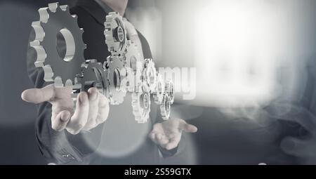 businessman hand shows 3d cog gear to success concept Stock Photo