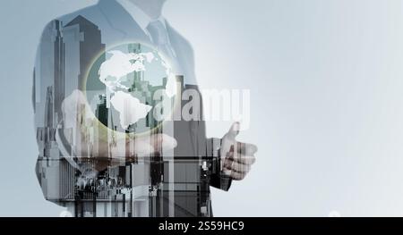 Double exposure of business engineer holding the earth and abstract city as concept Stock Photo