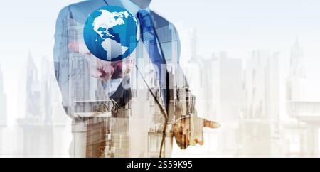 Double exposure of business engineer holding the earth and abstract city as concept Stock Photo