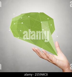 hand showing low poly geometric speech bubble with social media structure on white background Stock Photo