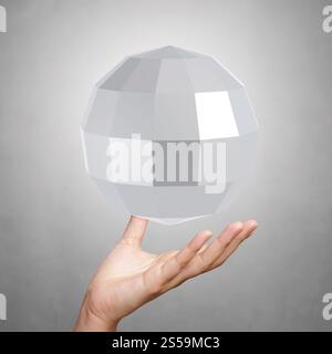 hand showing Abstract low poly 3d sphere on background Stock Photo
