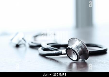 Stethoscope with digital tablet computer on wooden table and background Stock Photo