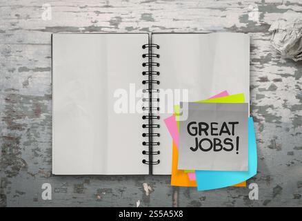 great job word sticky notes with open blank note book on desk top texture Stock Photo