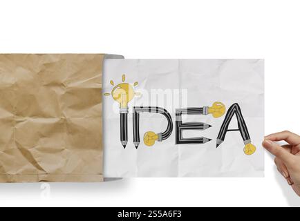 hand pulling crumpled paper from envelope with design word IDEA as concept Stock Photo