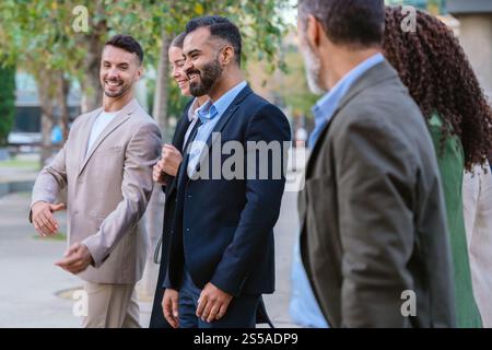 Group of Business Professionals Walking and Talking Outdoors Stock Photo